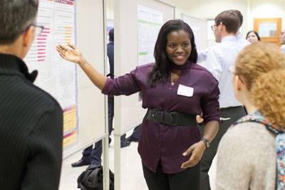 A student gladly discusses their research