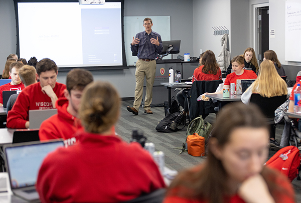 A professor presenting a lecture to a room of students