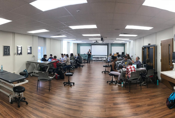 A large room with physical therapy treatment tables