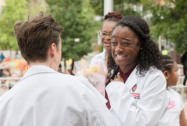 Ka'Derricka Davis celebrating starting medical school with a bouquet of flowers