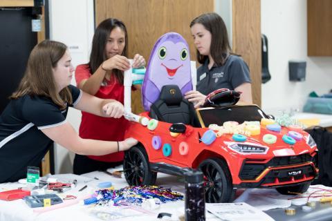 Three students working together on a project