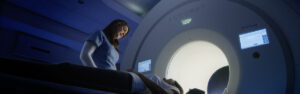 A medical provider supervising a patient during an imaging scan