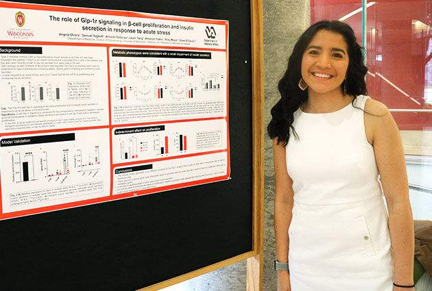 Angela Olvera standing next to her research poster