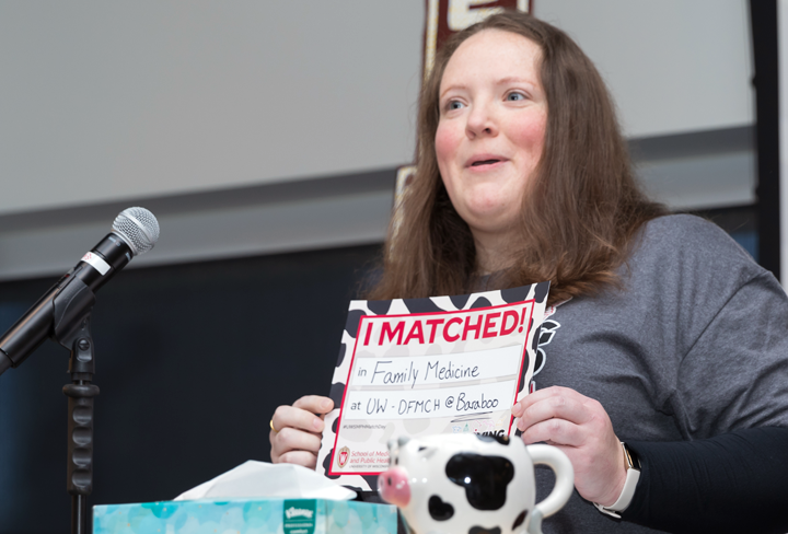 Faith Anderson holds an "I Matched" sign showing "Family Medicine at UW-DFMCH@Baraboo"