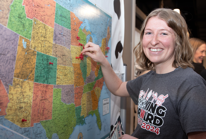 Hannah Cress places a pin on a map to show where she will do her residency