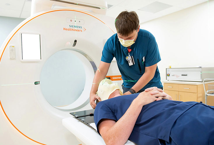 WARM students practice prepping fellow students for an MRI scan