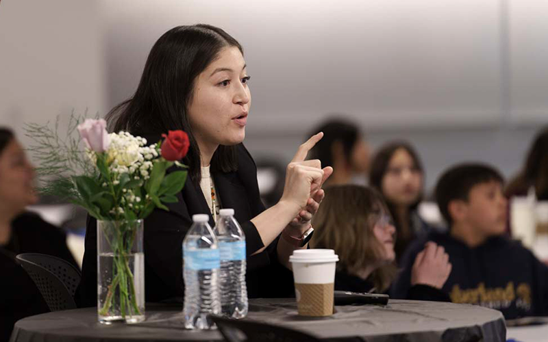 Alaqua Cox signing, using ASL, during her keynote presentation
