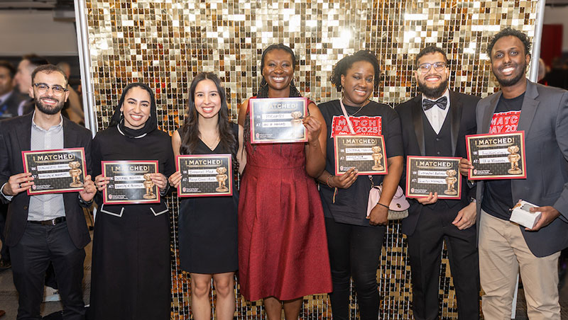 Group of smiling students holding "I Matched" signs