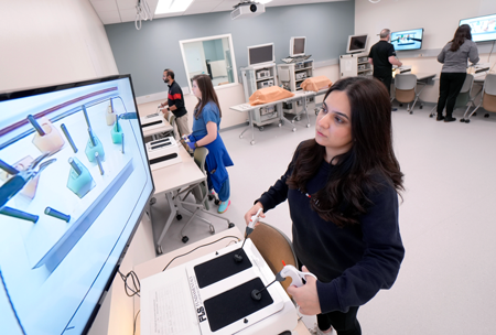 People using surgery simulators in a training lab.