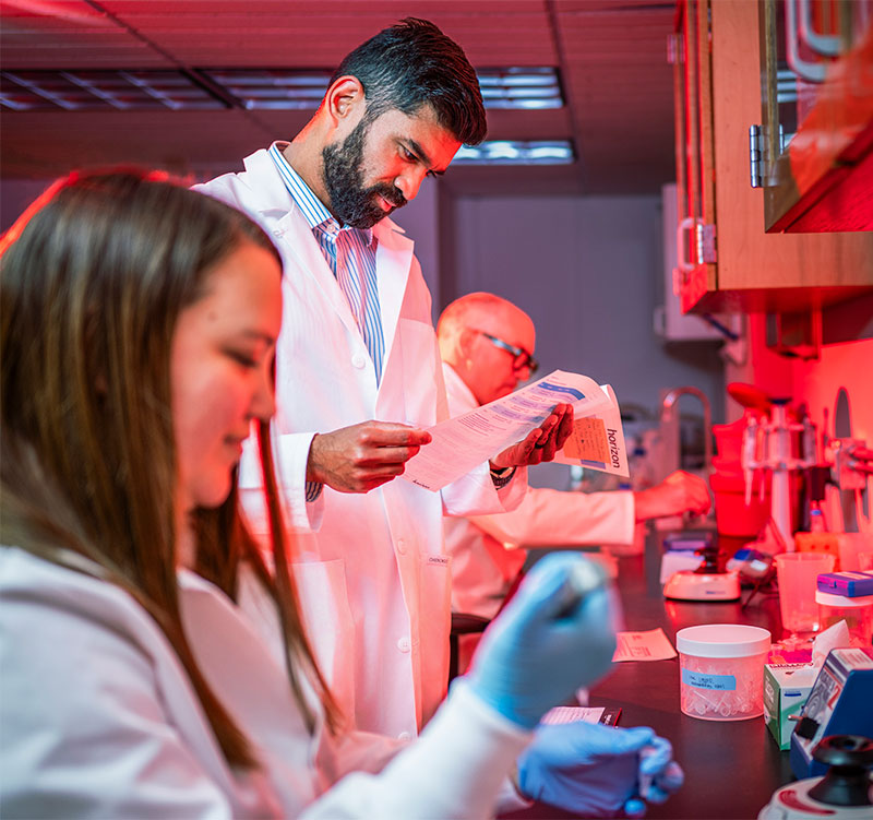 Faraz Choudhury works alongside colleagues in a lab