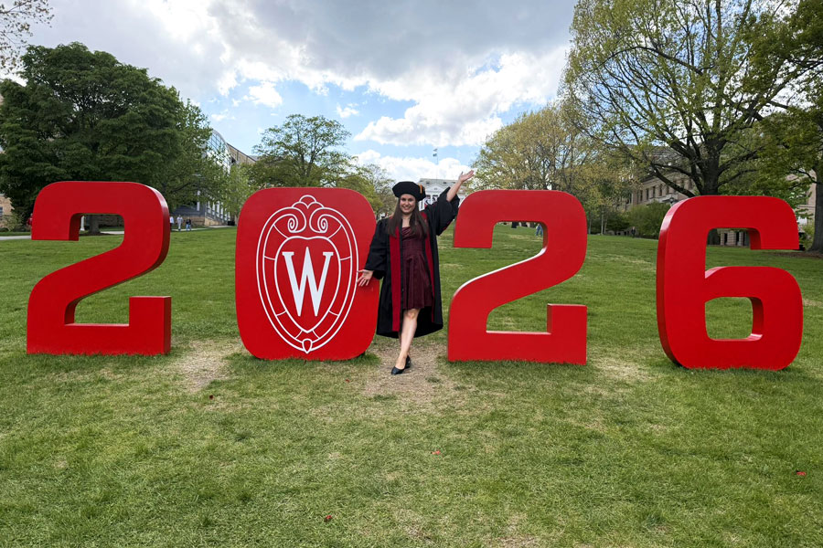 MD graduate Jessica Kaine poses with 2026 numbers on UW–Madison's Bascom hill.