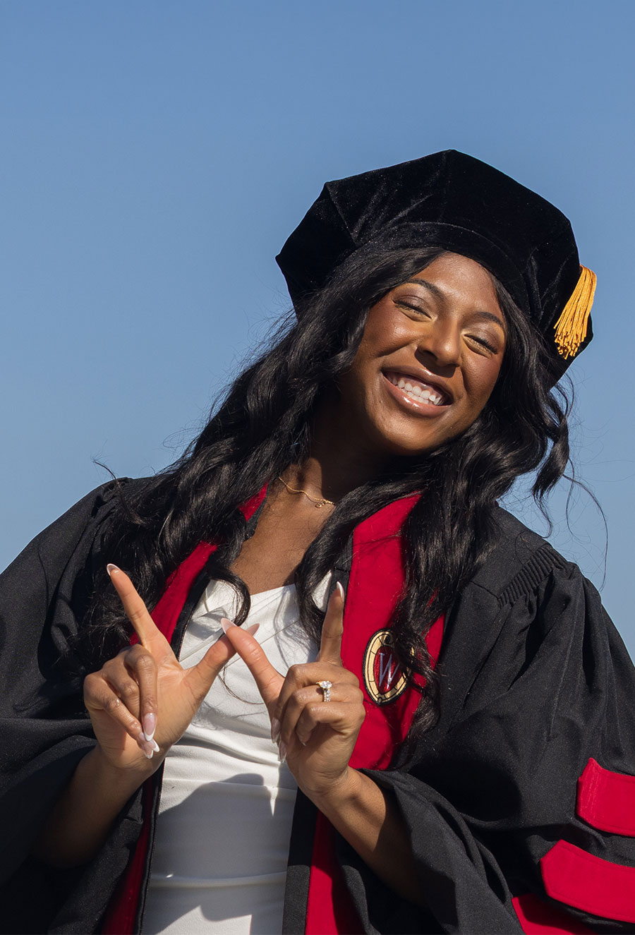 MD student Obie Oniah smiles on the UW Memorial Union Terrace after graduation.