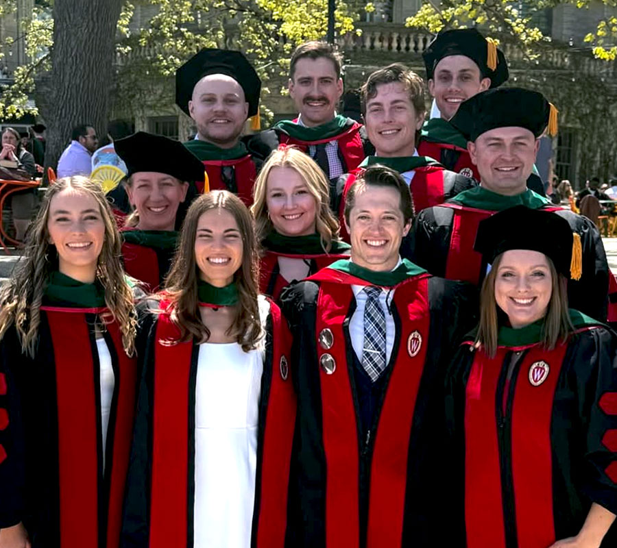 Wisconsin Academy for Rural Medicine graduates wearing caps and gowns at the UW Memorial Union Terrace