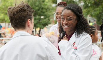 Ka'Derricka Davis celebrating starting medical school with a bouquet of flowers