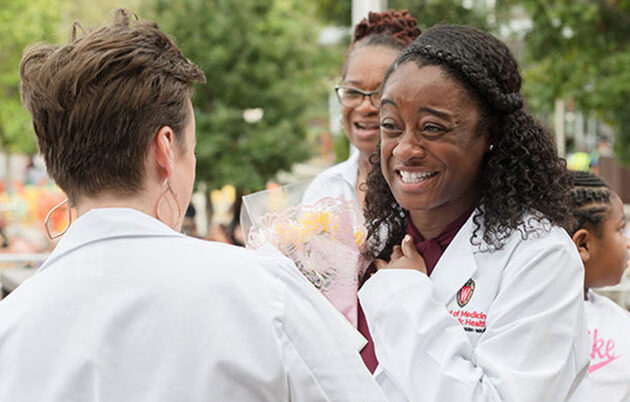 Ka'Derricka Davis celebrating starting medical school with a bouquet of flowers