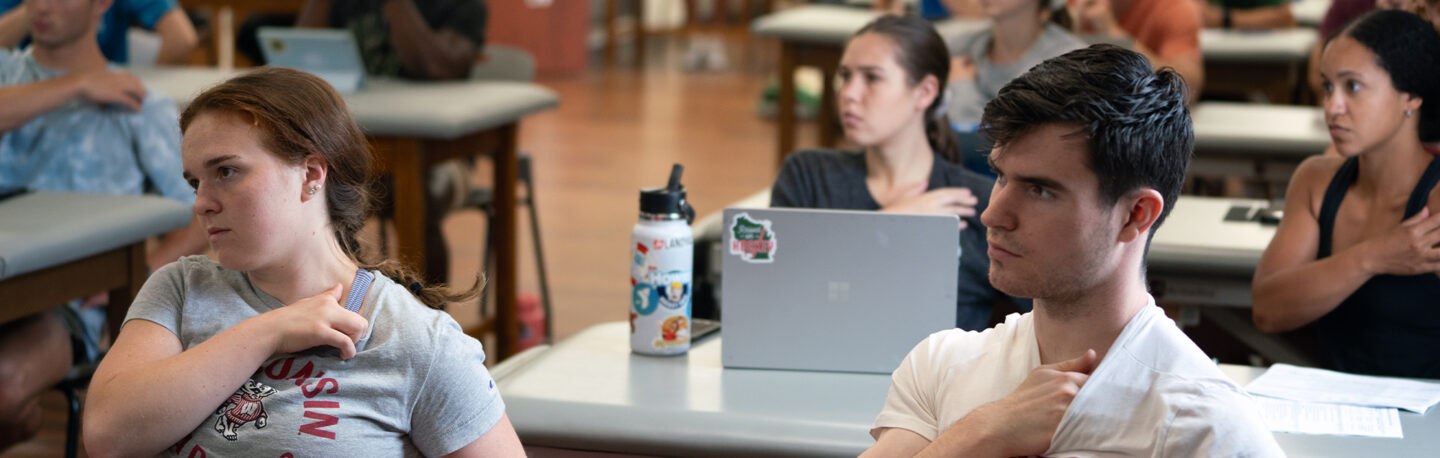 Students feel their own clavicle as part of a class lecture