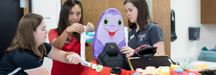 Three students working together on a project