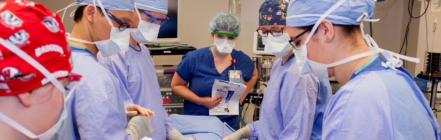 MD students in scrubs and masks