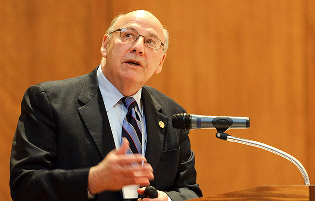 Paul DeLuca speaking at a podium