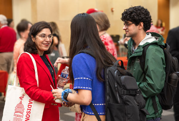 Dean Ahuja shakes a student's hand at a school event