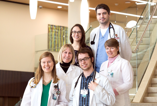 Faculty physicians and students smile together