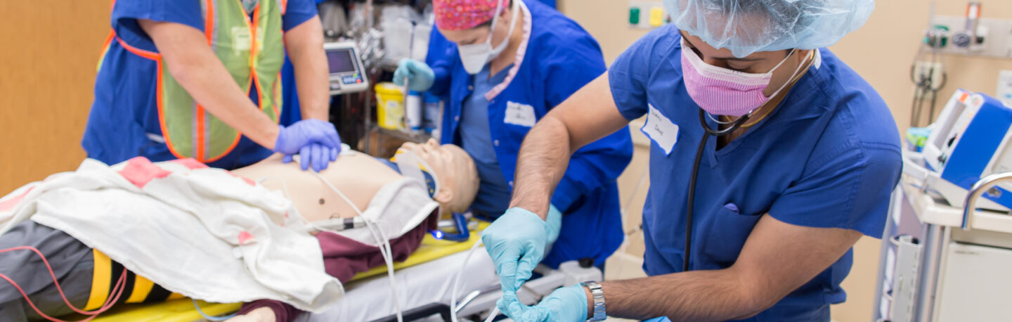 A group of students practicing hands on clinical skills