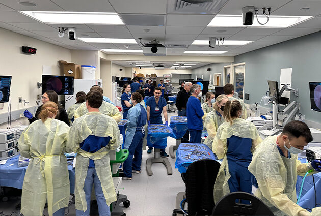 The clinical simulation facility at UW Hospital filled with students engaging in hands on learning.