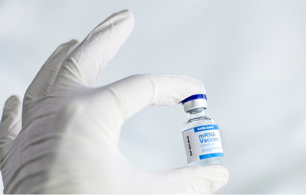 Vaccine bottle held in hand