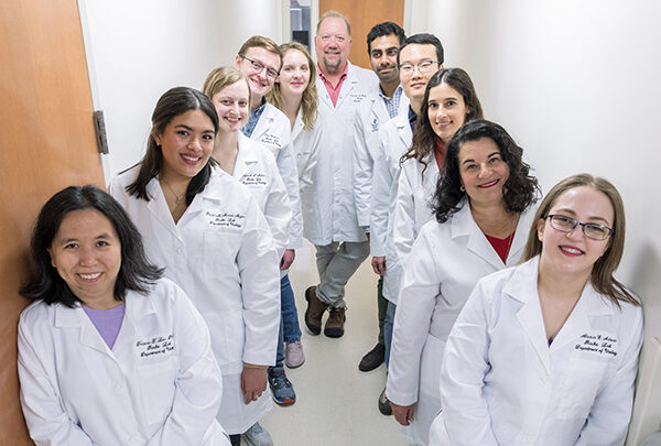 A team of smiling researchers