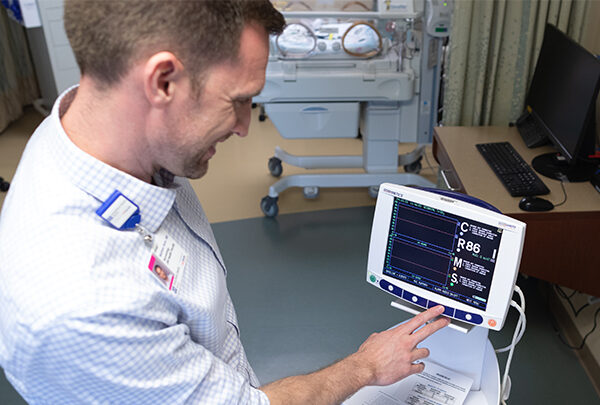 A researcher checks the status of a medical device