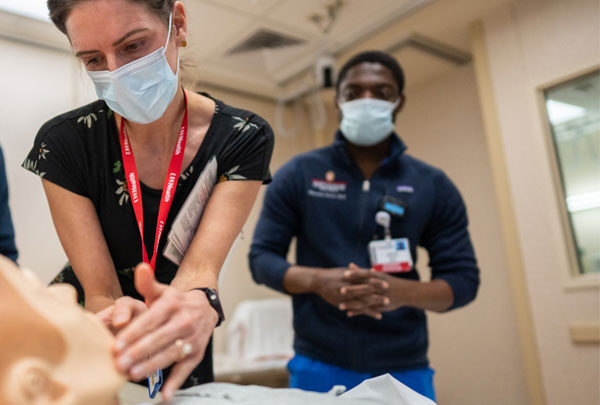 Woman works with a mannequin in the Clinical Simulation facility