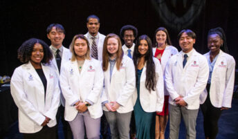 Nia Foster and fellow first-year students at the white coat ceremony