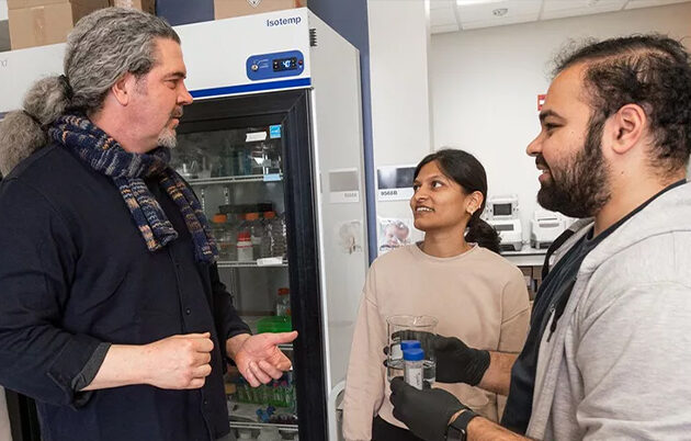 Chapman and researcher in the lab