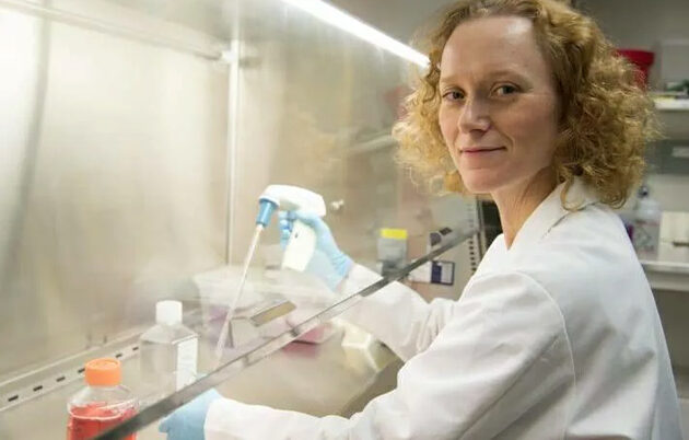 A scientist using a pipette in a laboratory