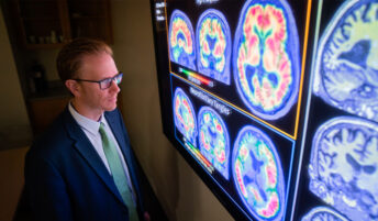A man analyzing brain scans.