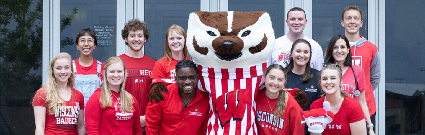 Smiling group of PA students pose with Bucky Badger