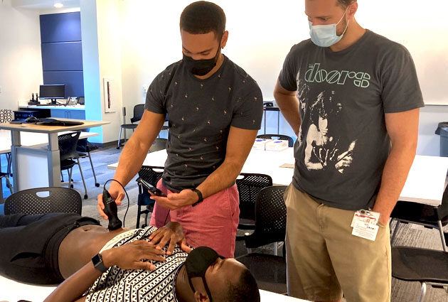 Students practice using an ultrasound machine