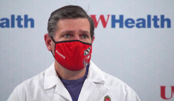 A masked Badger health care professional in an interview