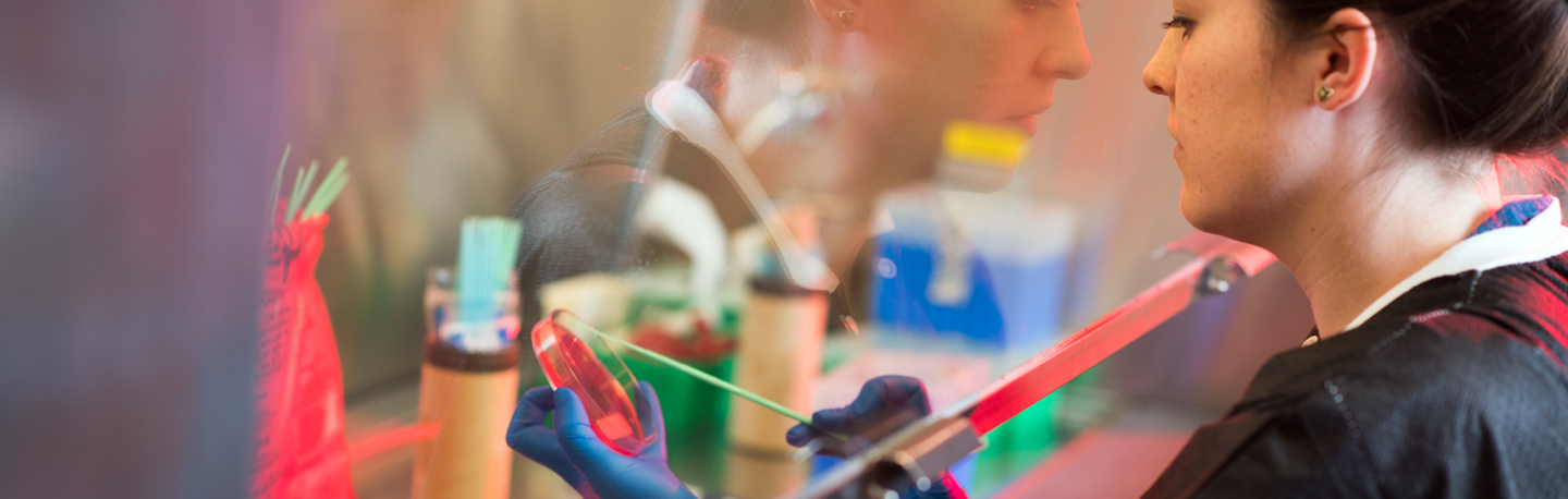 woman working in a lab fume hood