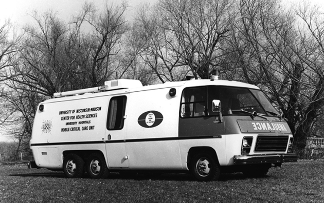 A UW ambulance parked on grass