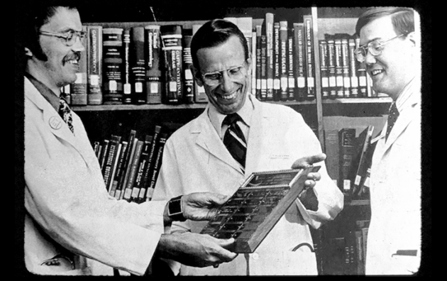 Dr. William Kisken being handed a plaque by another physician