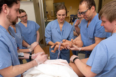Rural medicine students students practice delivering babies in a simulation lab in La Crosse, Wisconsin