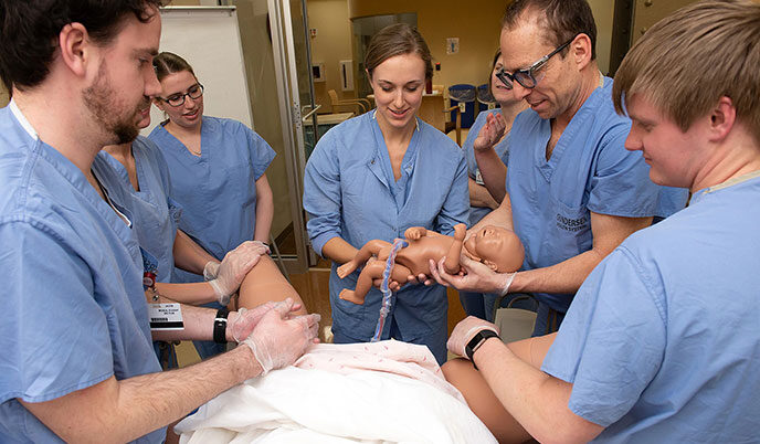 Rural medicine students students practice delivering babies in a simulation lab in La Crosse, Wisconsin