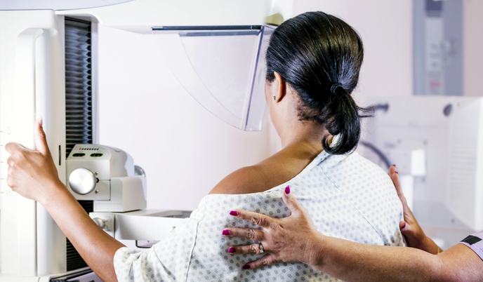 Woman standing at a mammography machine