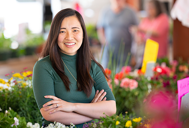 TRIUMPH student KaHoua Yang at her project site, Fondy Food Center's Milwaukee Market Match