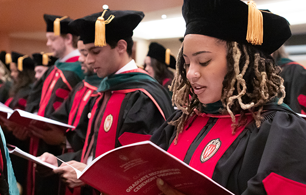 MD graduates read from their programs