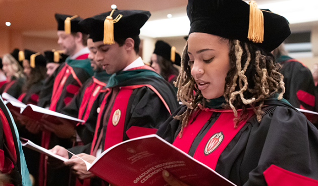 MD graduates read from their programs