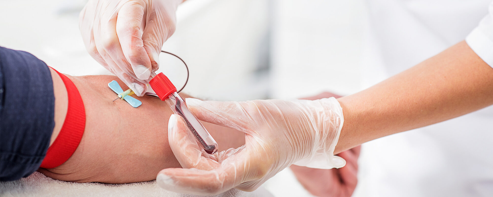 A health care professional taking a patient's blood sample