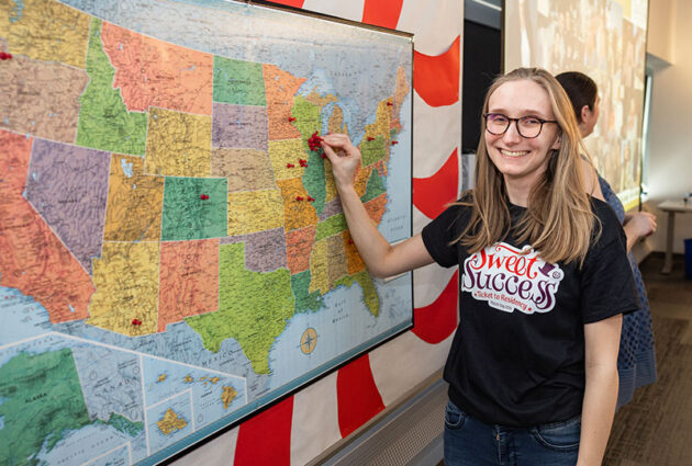 Helia Gagnon places a pin on a U.S. map where she matched
