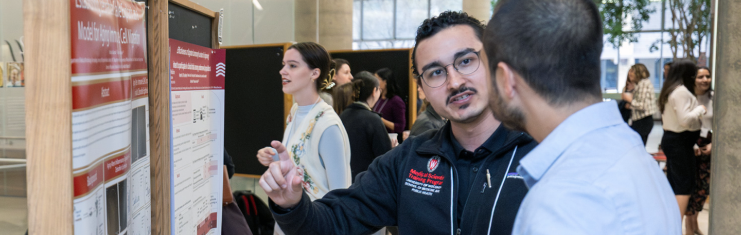 MSTP student discussing their research poster